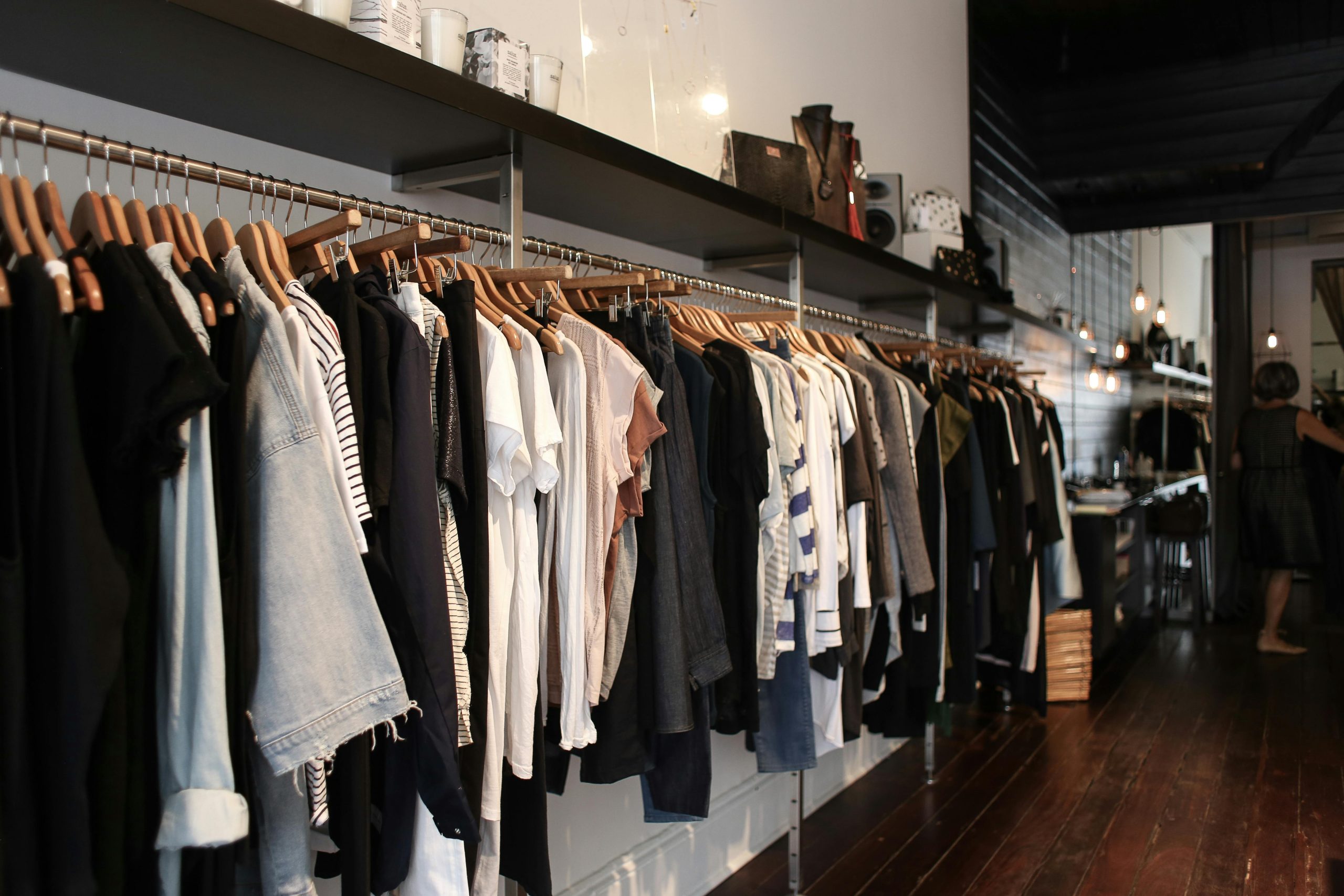 Clothes hanging on wall rack inside boutique