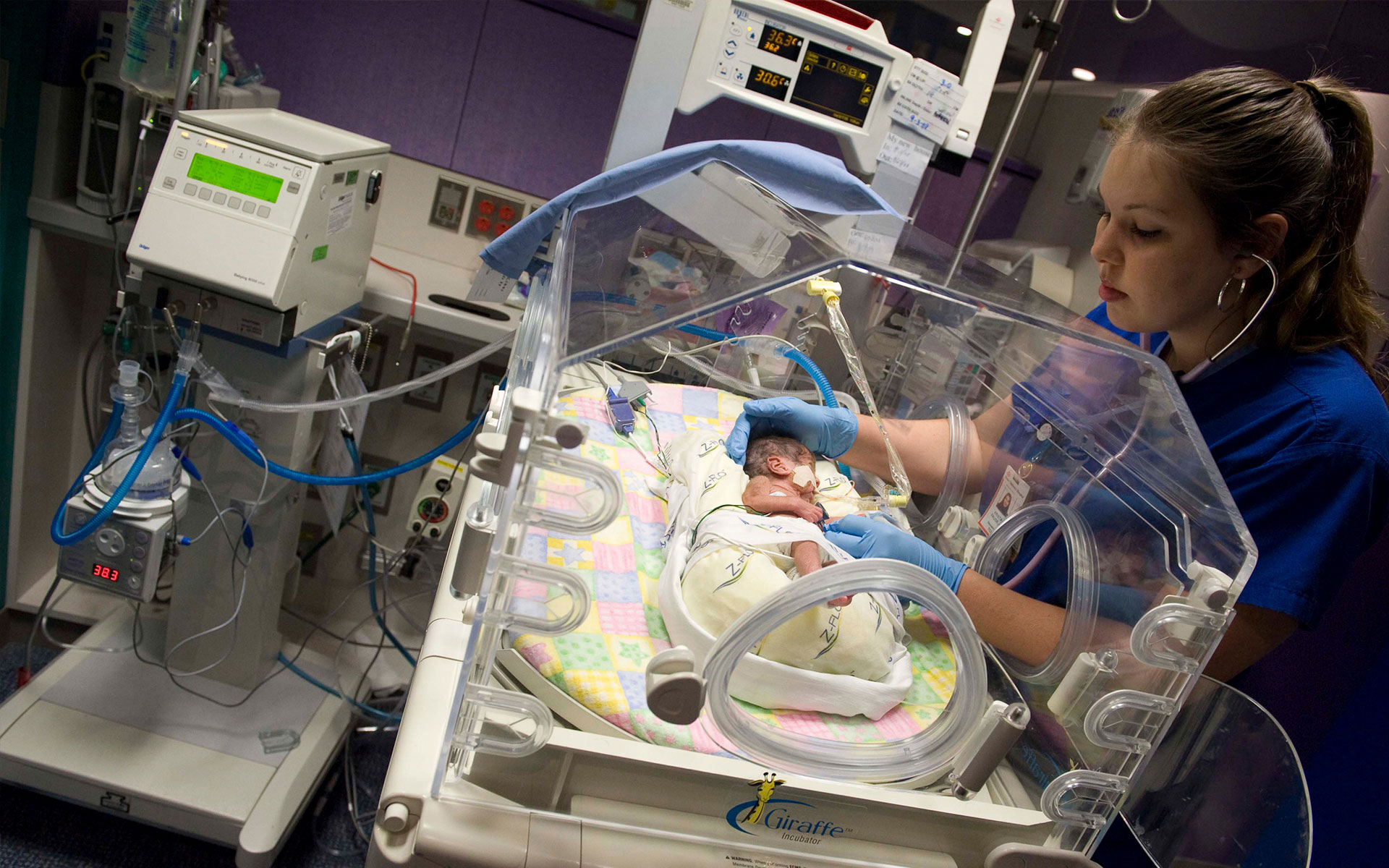 Nurse leaning over an infant